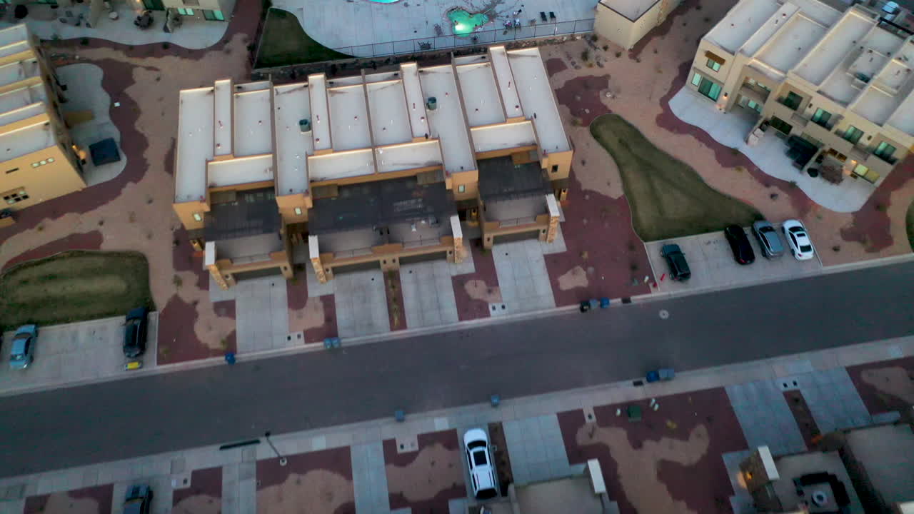 St. George, Utah USA. Beautiful aerial shot over the houses and roads and of the hills and mountains at dusk, flying over a swimming pool. Establishing shot of the area