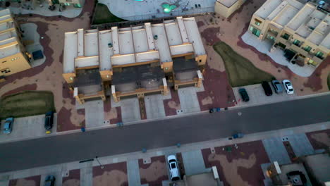 st. george, utah usa. beautiful aerial shot over the houses and roads and of the hills and mountains at dusk, flying over a swimming pool. establishing shot of the area