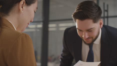 male candidate being interviewed in office for job by female interviewer 2