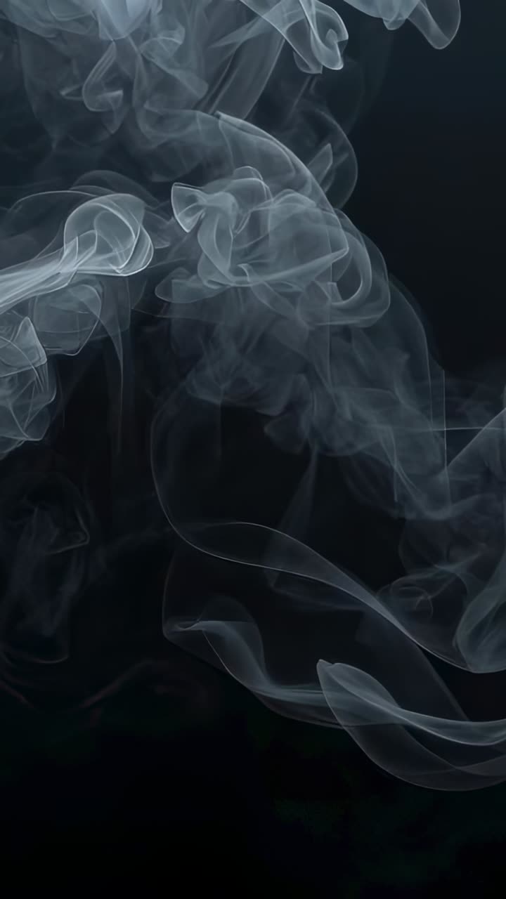 Video verticale: rilascio di una colonna di fumo sottile e ondulata che si disperde su uno sfondo nero con nastri
