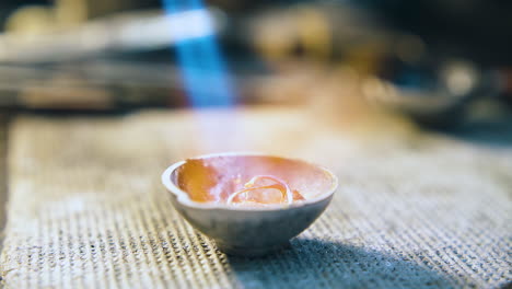 gold-rings-melt-in-crucible-with-torch-flame-close-view