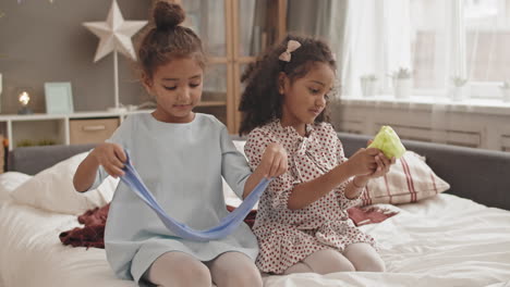 girls playing with slime toys