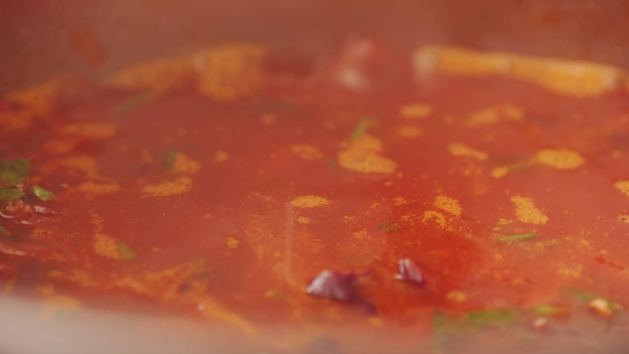 Beetroot soup, Cooking traditional national Russian, Ukranian soup Borsch close-up. Boiling red soup with vegetables and turkey meat and spices. Special red for Borsh from beet, tomatoes pasta