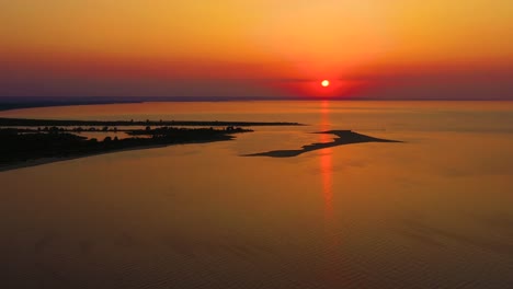 4K-UHD-Aerial-drone-view-Beautiful-sunset-over-tropical-beach-with-clouds-In-the-middle-of-the-sea