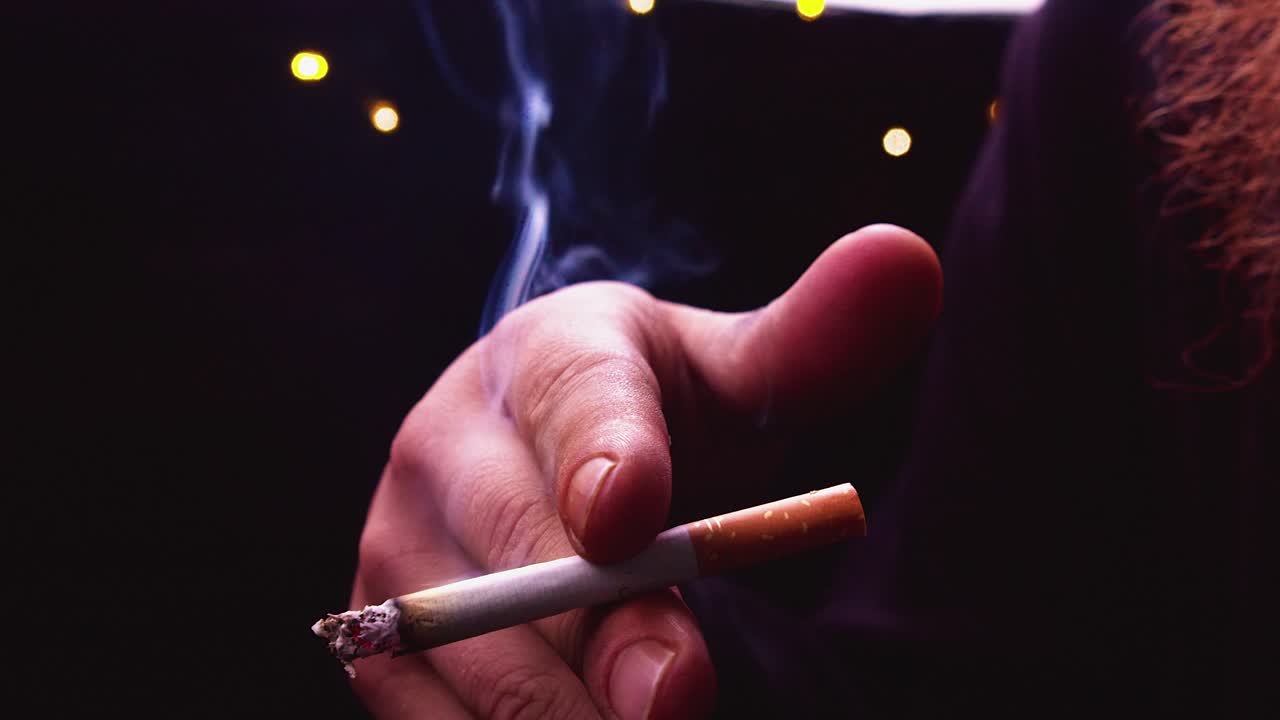 Back light closeup: Red bearded man smokes cigarette in slo mo, smoke