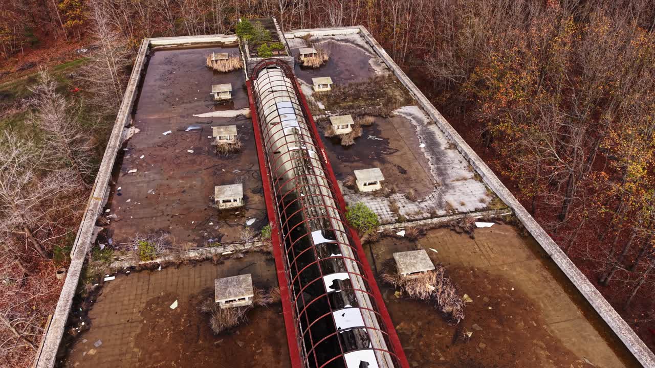 Exploring the abandoned facility surrounded by nature in autumn