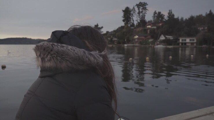woman sitting by the lake