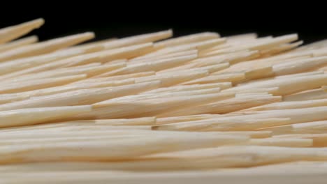 Close Up of Bamboo Toothpicks on a Dark . Close up of bamboo toothpicks on a dark . Video made of wooden toothpicks