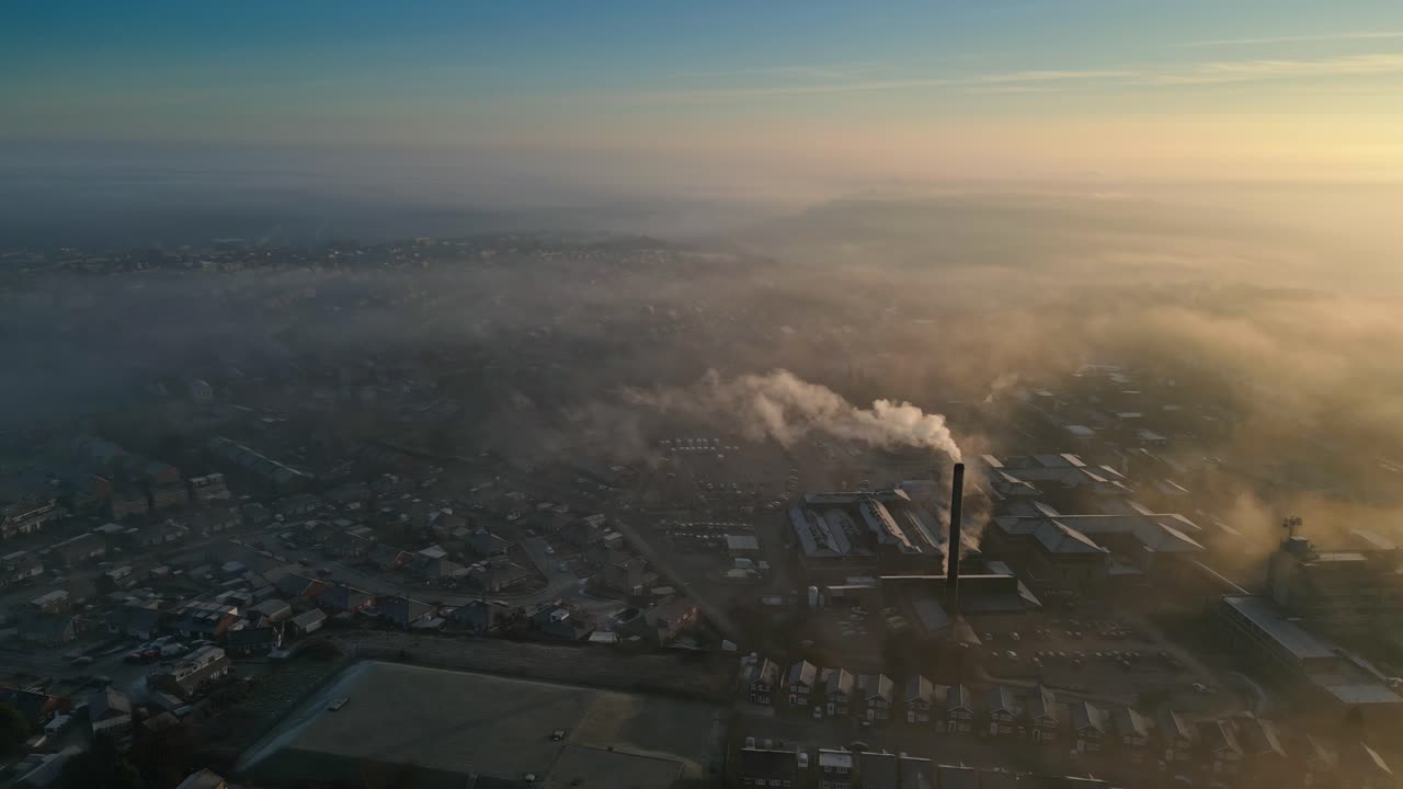 Aerial Drone Shot Above Industrial Urban townscape areas shrouded In morning mist