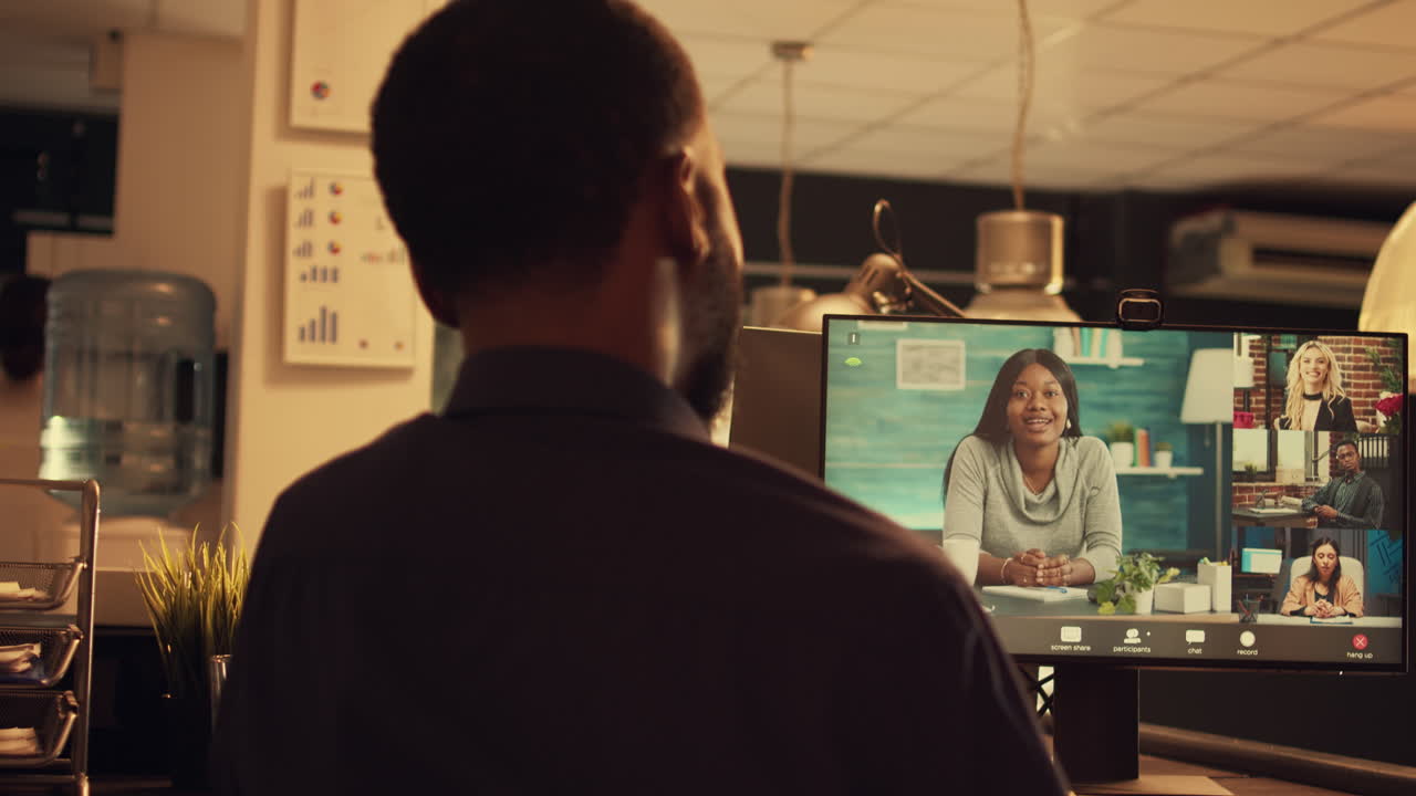 Office worker attending online videocall meeting on computer