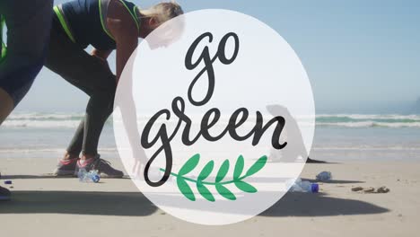 animation of go green text and logo over two caucasian women picking up rubbish from beach