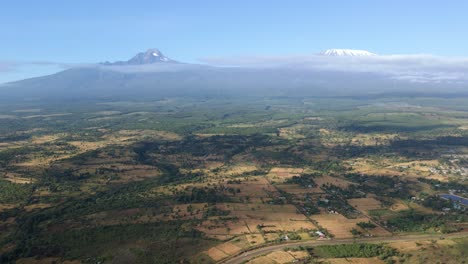 aerial view over rural kenya, mountain in the background - reverse, drone shot