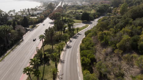 wide high angle aerial of two riders on motorbike in marbella spain