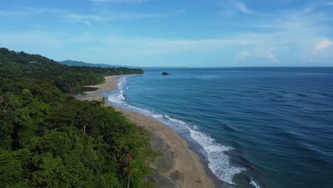 puerto viejo, costa rica - january 18, 2023: aerial drone shot of the lush forest, the beach and the sea near the town