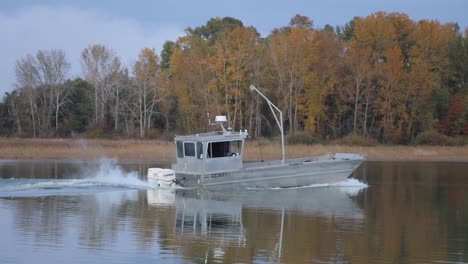 fishing boat on river in autumn