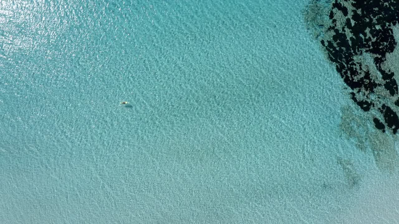Vista drone dall'alto di una tavola da stand up paddle lungo le acque poco profonde di Minorca.