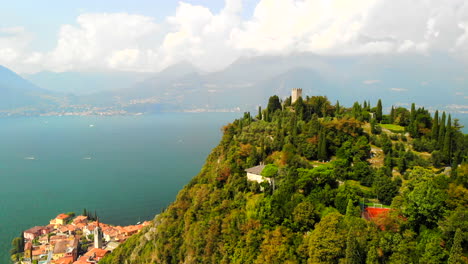 drone shot of varenna, italy, with view of lake como and castello di vezio