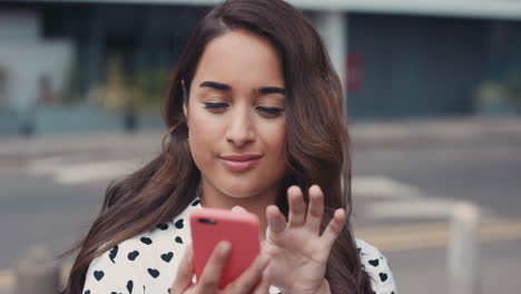 slow motion portrait of beautiful indian woman smiling using smart phone