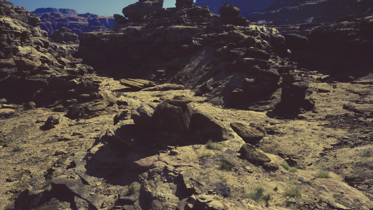 Unique rock formations in a vast desert landscape under clear blue sky