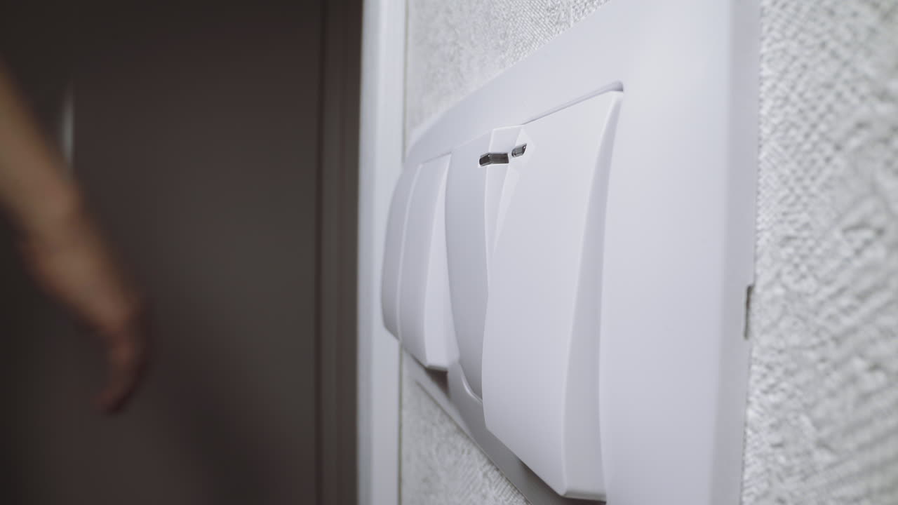 Lady presses switch key to turn on light to come into room
