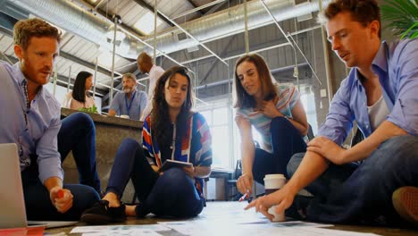 business colleagues discussing over document 4k