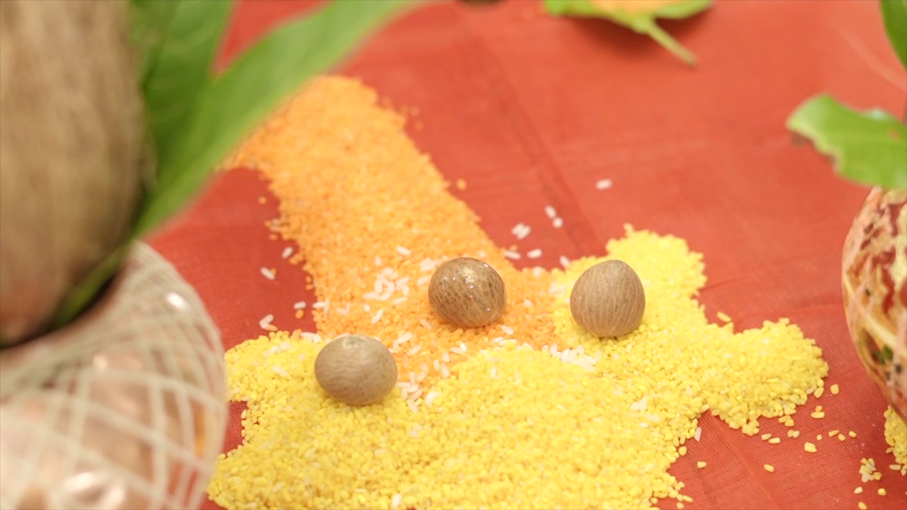Allestimento di un tradizionale rituale indù con Akshata dai colori vivaci e noci di betel sacre, che simboleggiano benedizioni, prosperità e devozione durante cerimonie religiose propizie.