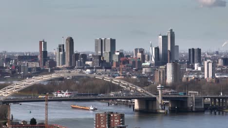 Skyline-of-Rotterdam-With-The-Van-Brienenoord-Bridge-in-the-Foreground,-Establishing-Aerial-Shot,-Slow-Motion