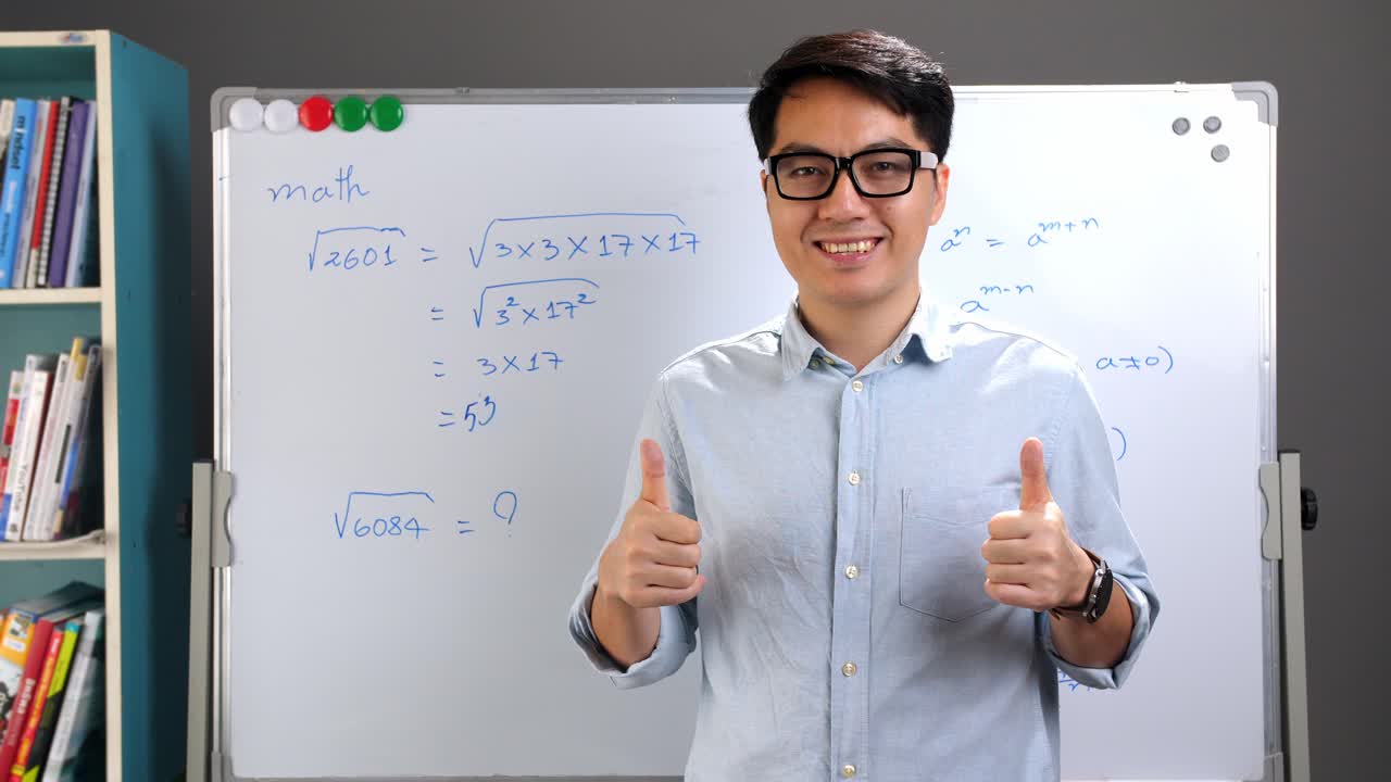 Male Asian Teacher With A Thumbs Up