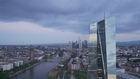 dark skyn over moody european central bank ecb tower in frankfurt am main germany from a drone at sunrise 4k