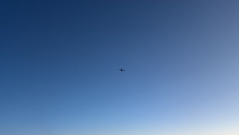 an aerial view from inside a jet cockpit of an aerial jet crossing while flying at sunset at high altitude.