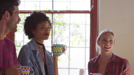 five friends stand hanging out in kitchen, waist up, shot on r3d