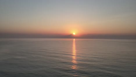 Aerial-Drone-Shot-of-a-Beautiful-Calm-Sunrise-Over-the-Gulf-of-Thailand-with-Reflection