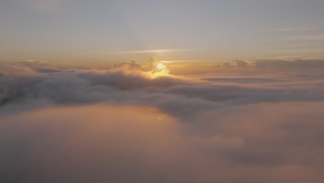 heavenly aerial flight above the clouds with breathtaking sunset