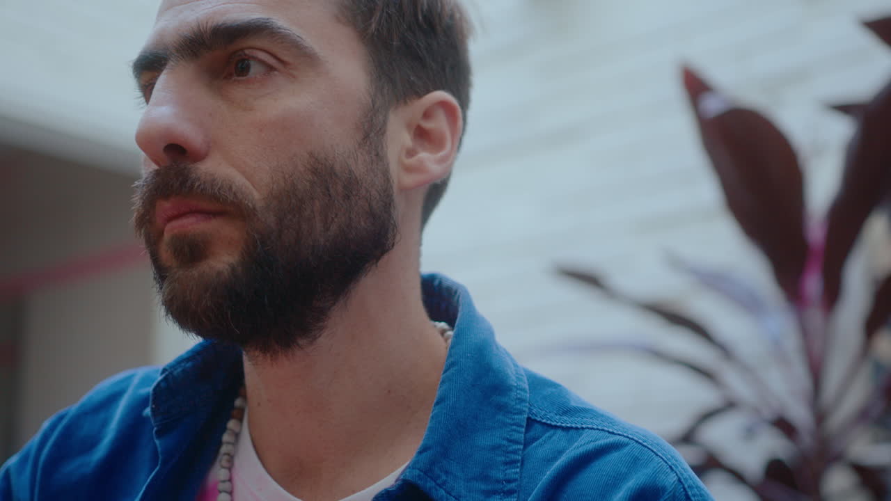 Man Playing the Guitar Outdoors on a Balcony