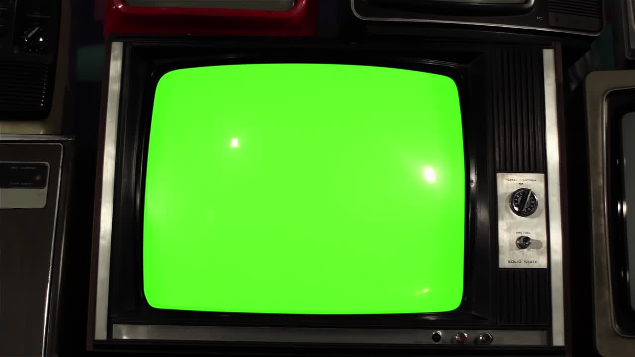Pile of Old TVs and Retro Television with Green Screen. Fast Dolly In. 4K Resolution.