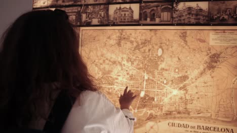 person looking at a historical map of barcelona