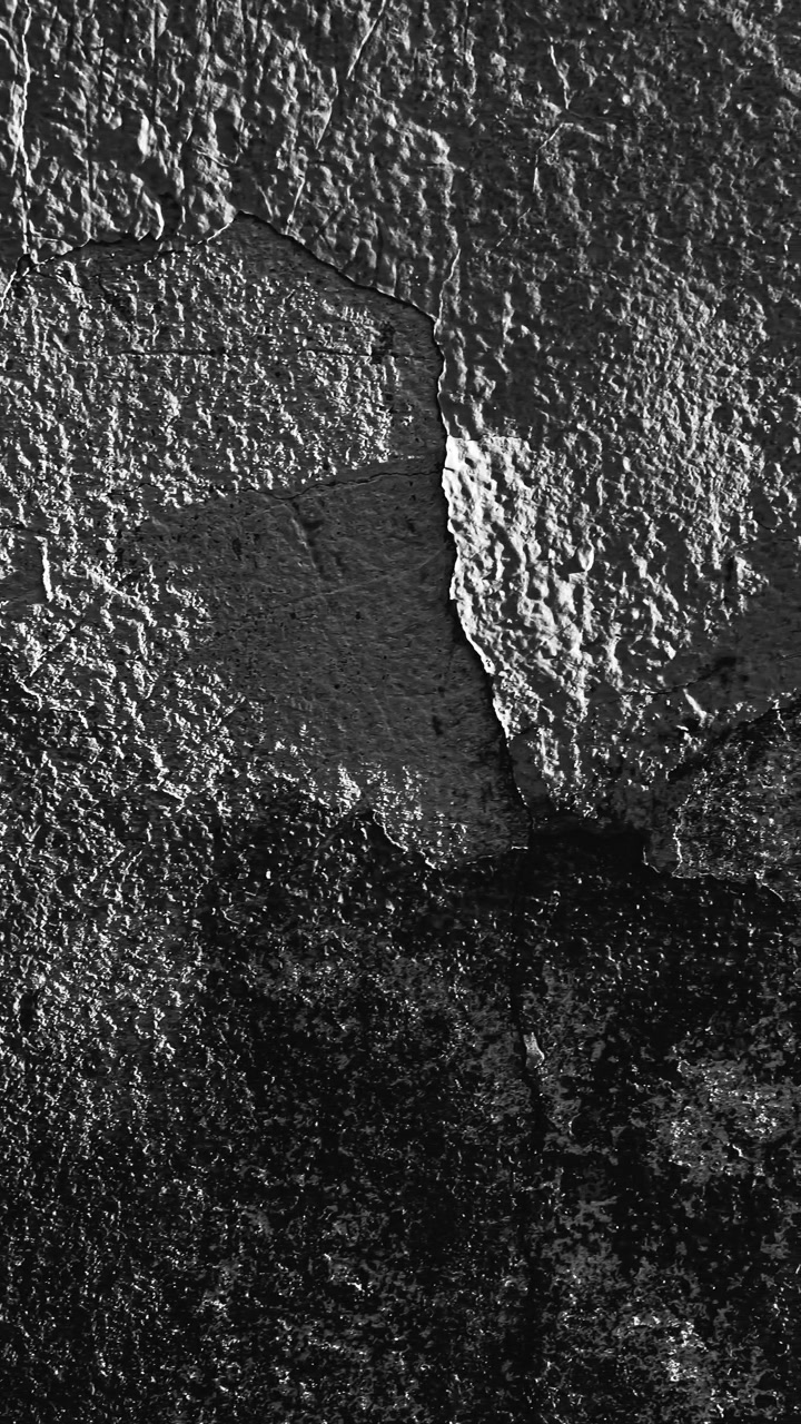 Peeling paint on textured wall