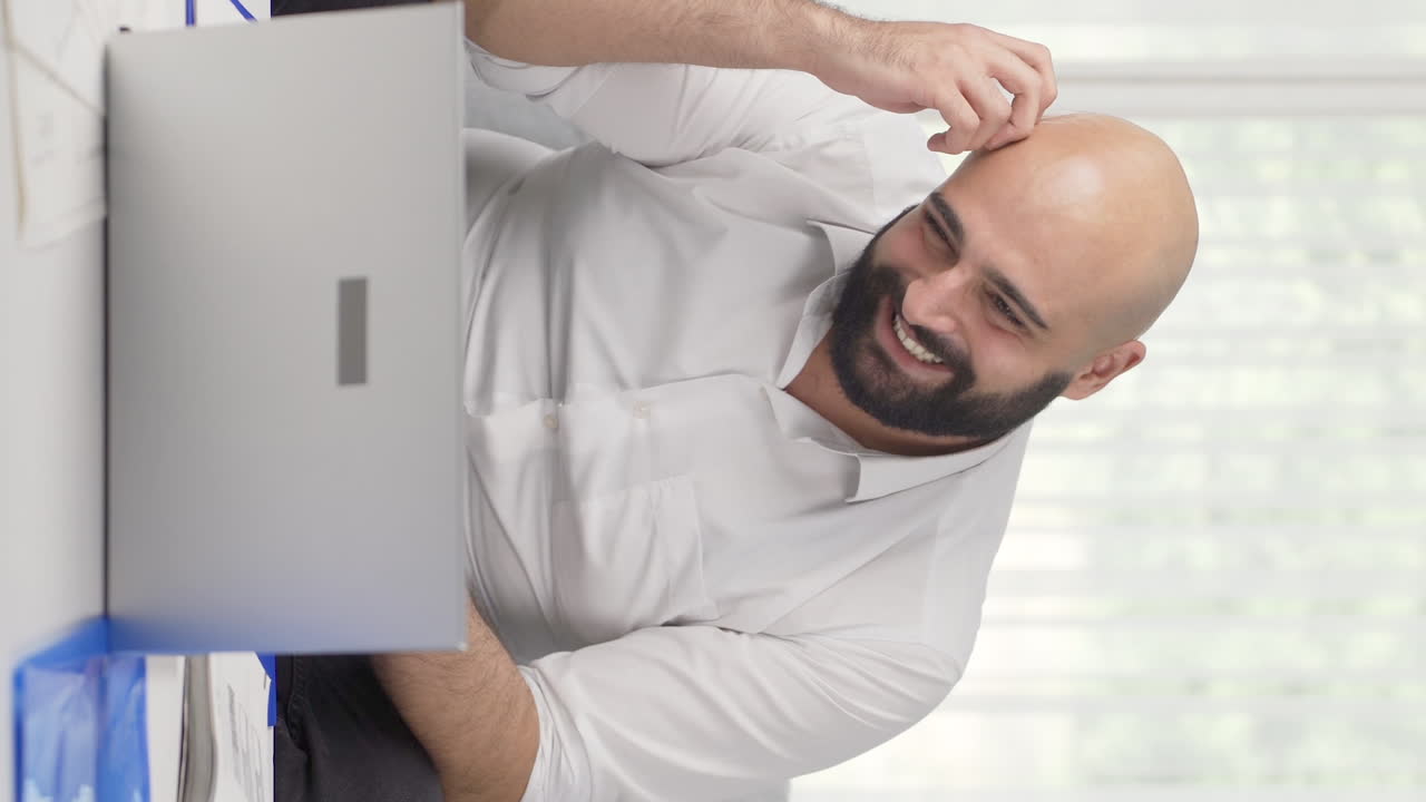 Vertical video of Home office worker man experiencing joy.