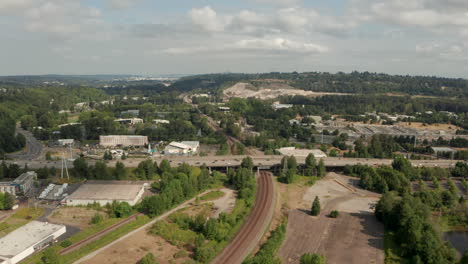 Aerial-shot-towards-an-American-freeway-over-a-train-track