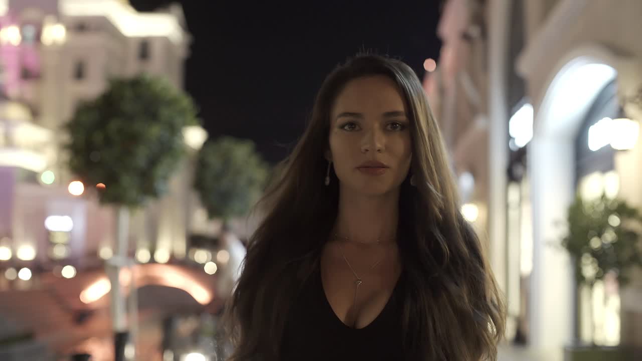 Beautiful girl in the background of a night city