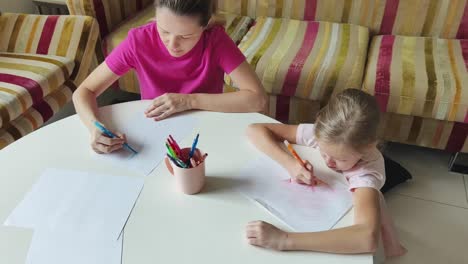 madre e hija dibujando juntos en casa