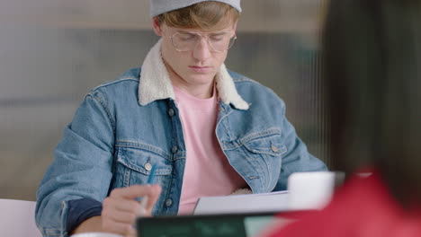 young caucasian man student using laptop computer brainstorming working on creative project browsing online research study in office workspace