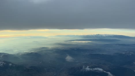 A-pilot’s-point-of-view-of-Sierra-Nevada,-in-Spain,-in-a-cold-winter-day-with-a-dramatic-sky