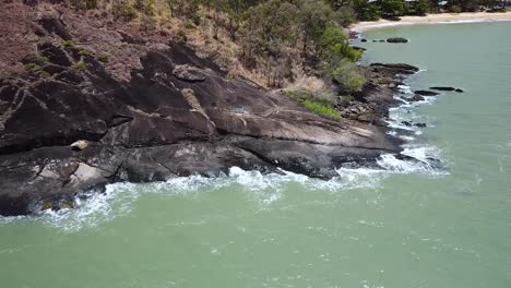 Aerial-Of-Waves-Crashing-Onto-Rocks-At-Trinity-Beach-In-Cairns