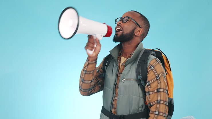 Megaphone, talking and a black man on a blue