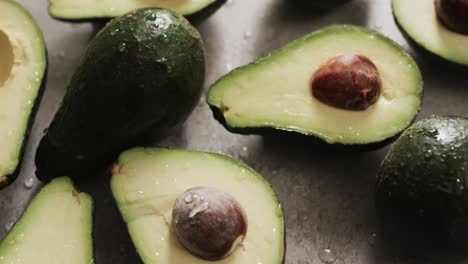 micro video of close up of avocados with copy space on grey background