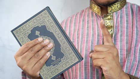 man holding a quran