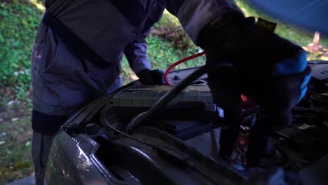 mechanic turning power to a car