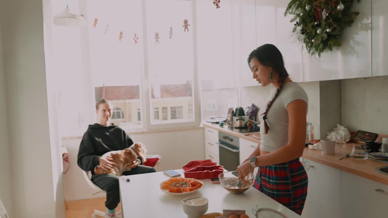 People and a Dog in a Christmas Decorated Kitchen
