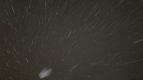 Falling down real snowflakes, heavy snow, snowstorm weather, shot on black background, matte, wide angle, seamlessly looped animation, isolated, perfect for digital composition, post-production.